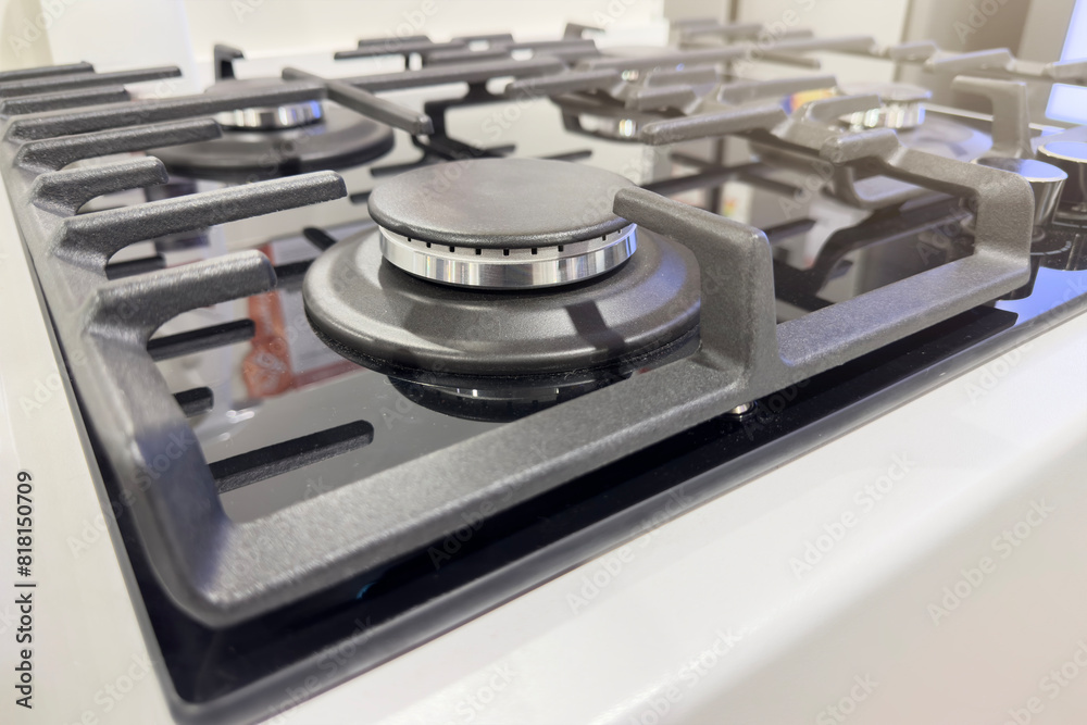 Close-up of a white gas stove in a store. Stove for cooking food. Close-up of a white gas stove in a store. Stove for cooking food.