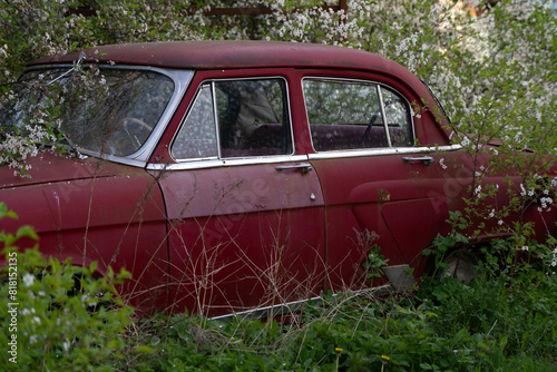 Old, retro, red, abandoned GAZ 21 car photo