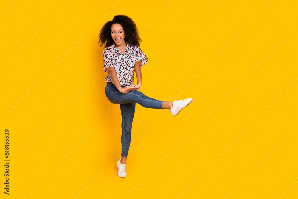 Full length photo of lovely young lady dancing enjoy disco dressed stylish leopard print garment isolated on yellow color background Full length photo of lovely young lady dancing enjoy disco dressed stylish leopard print garment isolated on yellow color background