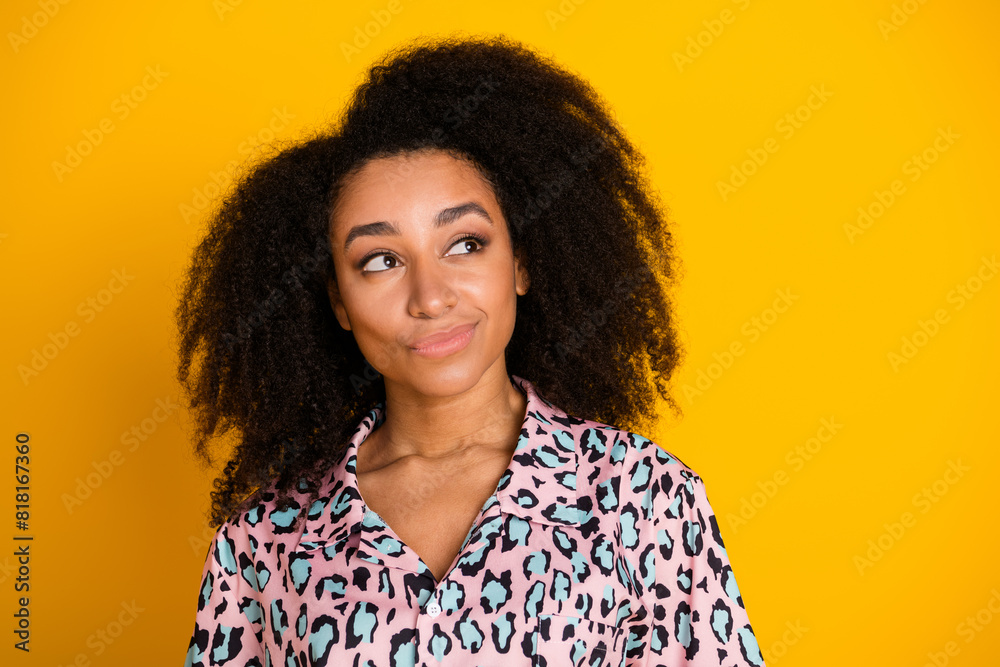 Photo portrait of pretty young girl look interested empty space wear trendy leopard print outfit isolated on yellow color background Photo portrait of pretty young girl look interested empty space wear trendy leopard print outfit isolated on yellow color background