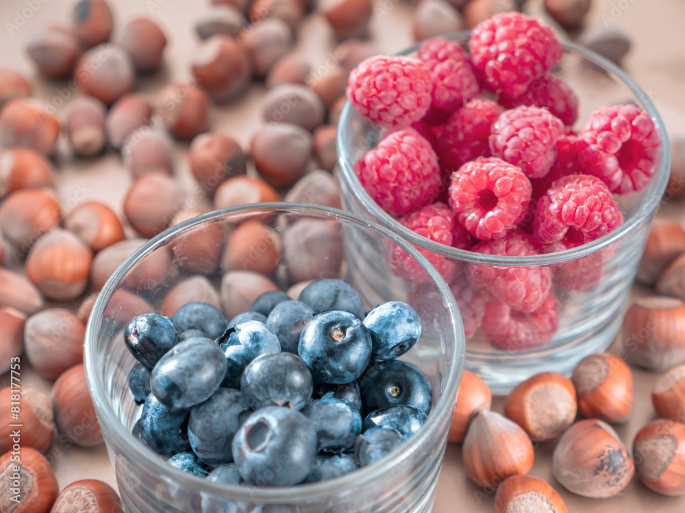 Nuts and juicy seasonal berries in the glassess. Summer and autumn food concept.