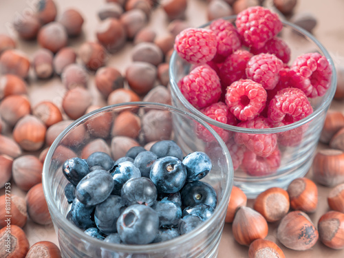 Obraz na płótnie Nuts and juicy seasonal berries in the glassess. Summer and autumn food concept. w salonie