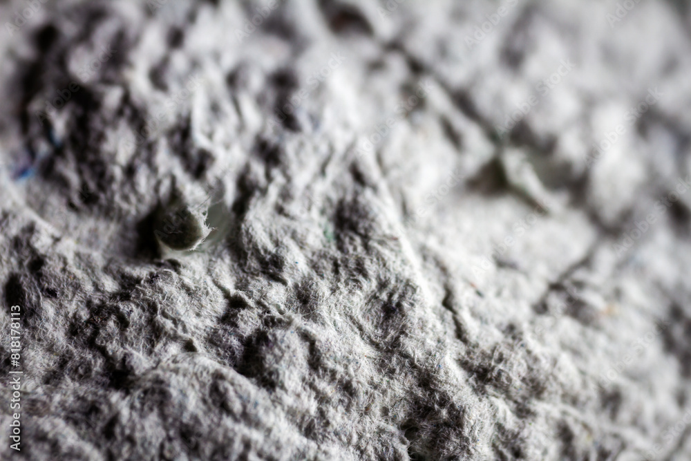 Extreme close up of old gray handmade paper mache with a structure and rough texture. Extreme close up of old gray handmade paper mache with a structure and rough texture.