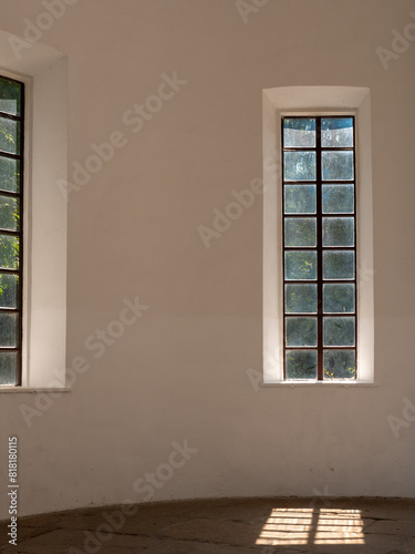 Light falling through the beautiful wooden high french window over the cracked rocky floor of an old chapel. Beautiful play of light and shade.
