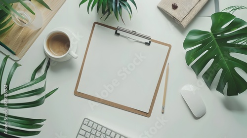Flat lay, top view office table desk. Workspace with blank clip board, keyboard, office supplies, pencil, green leaf, and coffee cup on white background.