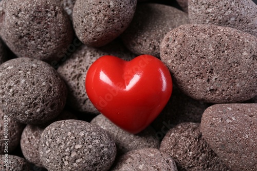 One red decorative heart on stones, above view