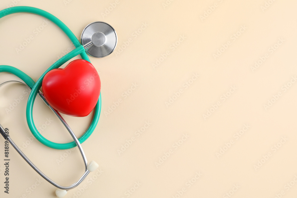 Stethoscope and red heart on beige background, top view. Space for text
