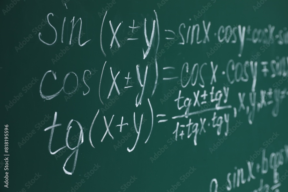 Many different math formulas written on chalkboard Many different math formulas written on chalkboard