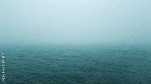  A large body of water heavily covered in fog and densely shrouded in smog