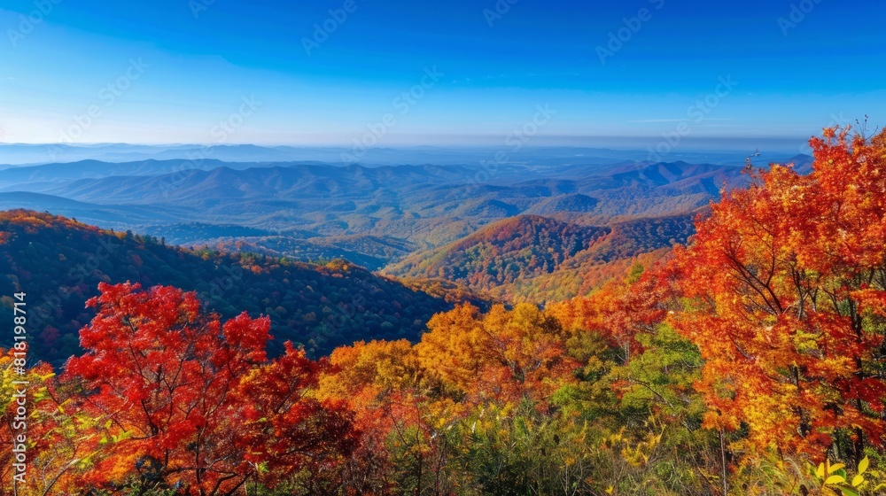 A majestic mountain range in autumn, with colorful foliage, clear blue skies, and a peaceful valley below, showcasing the beauty of nature in the fall season