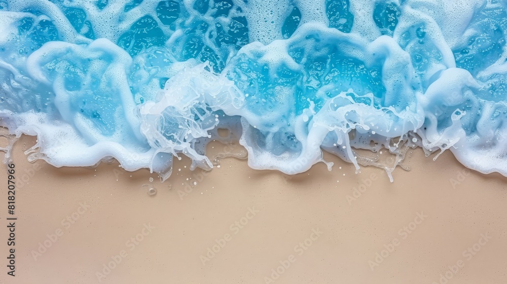 An aerial perspective of a wave crashing on a sandy shore, featuring blue-white foam atop and imprinting on the sand below An aerial perspective of a wave crashing on a sandy shore, featuring blue-white foam atop and imprinting on the sand below
