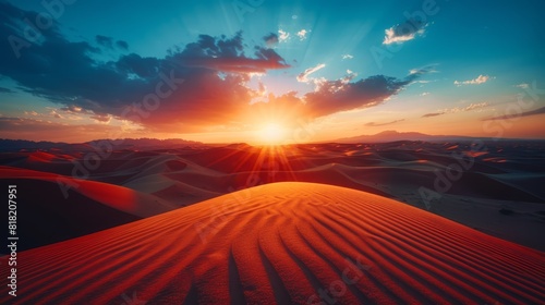  The sun sets over a desert landscape, featuring dunes and sandy foreground A blue sky above is adorned with wispy clouds and a few white ones (39 tokens photo