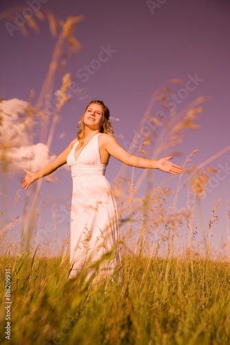 Young Woman Worshipping In A Field