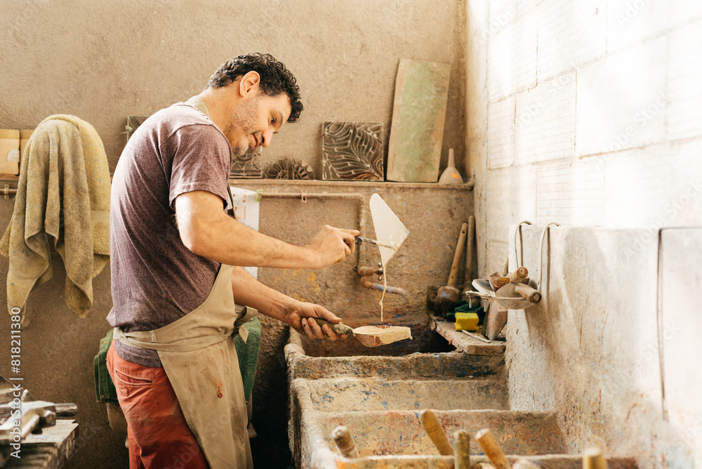 Man Mixing Colors to Make Cement Tiles in Factory During Daytime Man Mixing Colors to Make Cement Tiles in Factory During Daytime