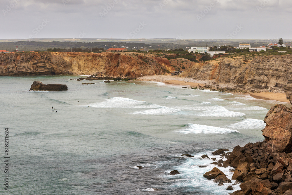 Elevated view of Praia do Tonel beach, Algarve, Portugal. The beach offers strong waves that draw surfers and paddle boarders
