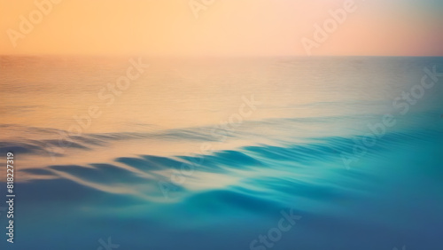 Water backdrop of smooth ocean waves in turquoise blue with glowing golden orange sky. Calm and relaxing atmosphere. Calming but colorful to lift the mood. © Ninja