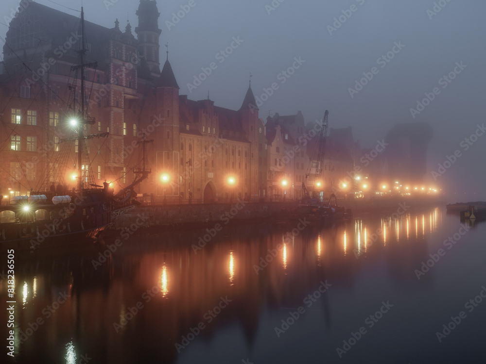 The old town of Gdańsk in the fog at night