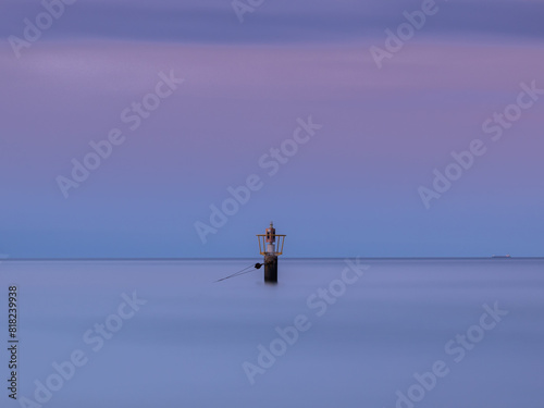 Obraz na płótnie Sea buoy on the background of the sunset on the Baltic coast w salonie