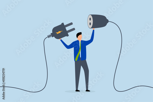 Business continuity, business manager plugs in a power cord to continue business.