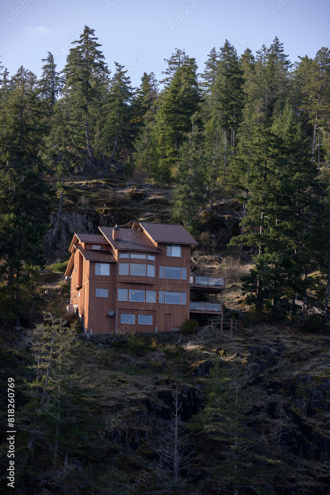 Wooden resort house perched on a forested cliff Wooden resort house perched on a forested cliff