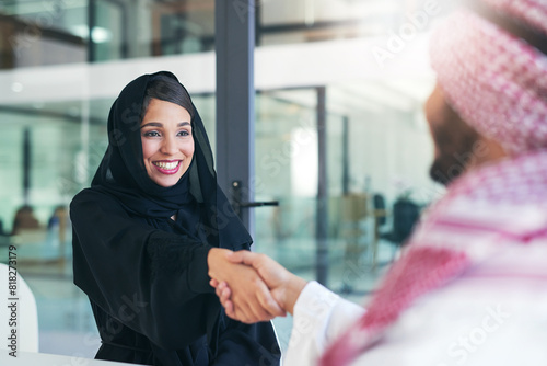 Arab, business and people with handshake in office, recruitment and muslim employee for greeting. B2b partnership, collaboration and congratulation gesture for deal, islam company and onboarding photo