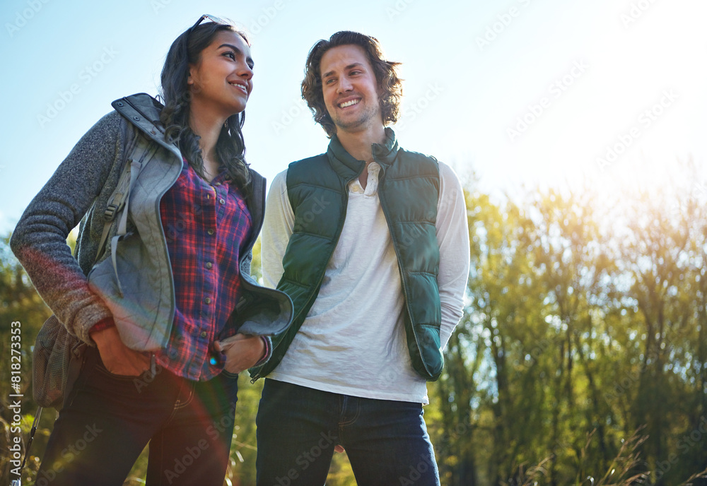 Happy, young couple in park or nature together for holiday, vacation and romantic weekend break. Smiling, man and woman relax in forest or green environment for peace, freedom and summer travel Happy, young couple in park or nature together for holiday, vacation and romantic weekend break. Smiling, man and woman relax in forest or green environment for peace, freedom and summer travel