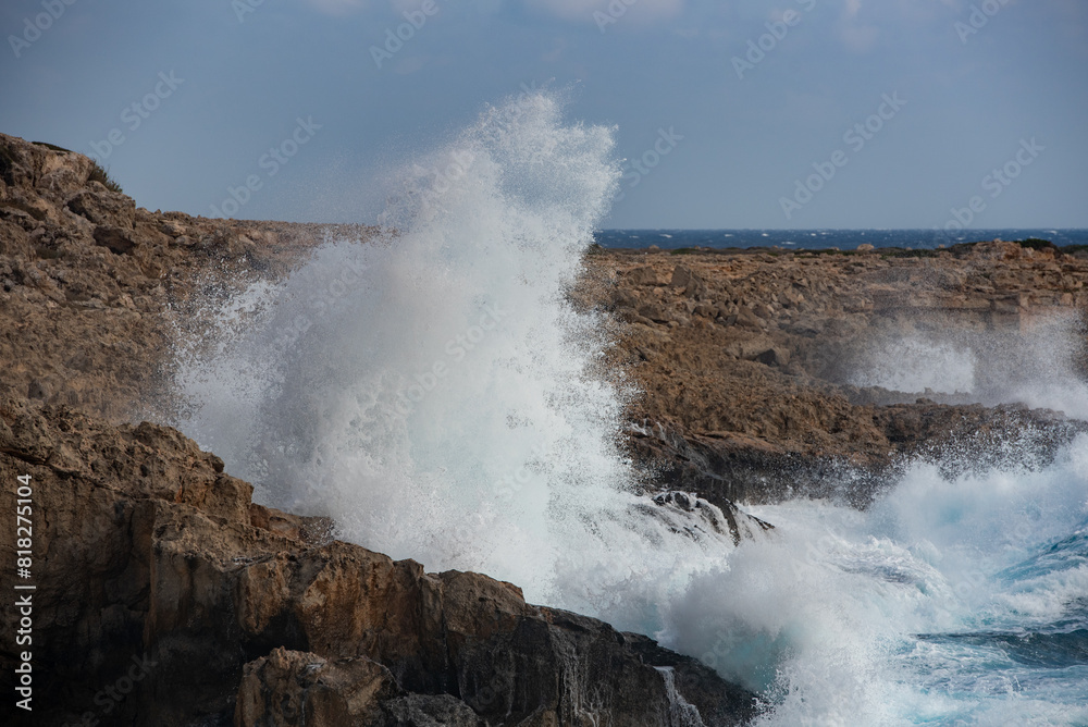 Windy sea waves crashing with power on the rocky coastline. Nature power wind stormy day