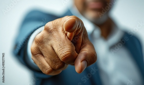 Close-up of a hand pointing directly at the camera, emphasizing focus and direction in a business context. photo