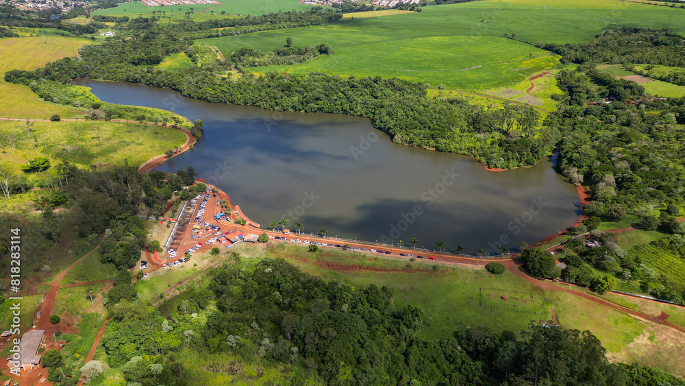 Fototapeta premium Lake surrounded by vegetation. Aerial view of the municipal Ecological Park of Fox in the city of Apucarana.