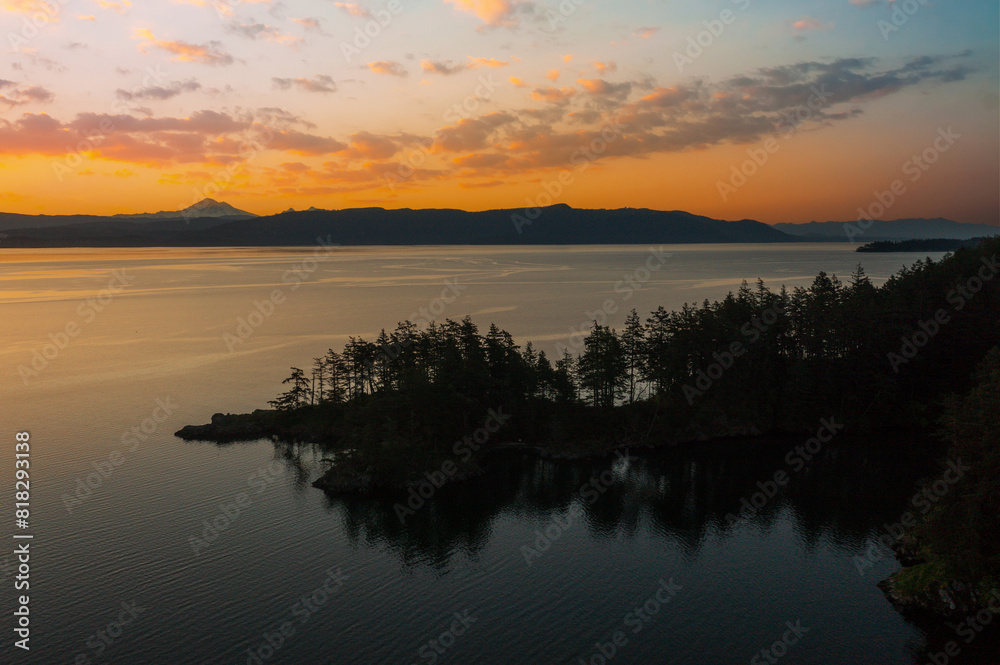 Abner Point on Lummi Island with Mt. Baker in the background. Seen from the Aiston Preserve with Smugglers Cove in the foreground and Bellingham Bay and the city of Bellingham in the distance.