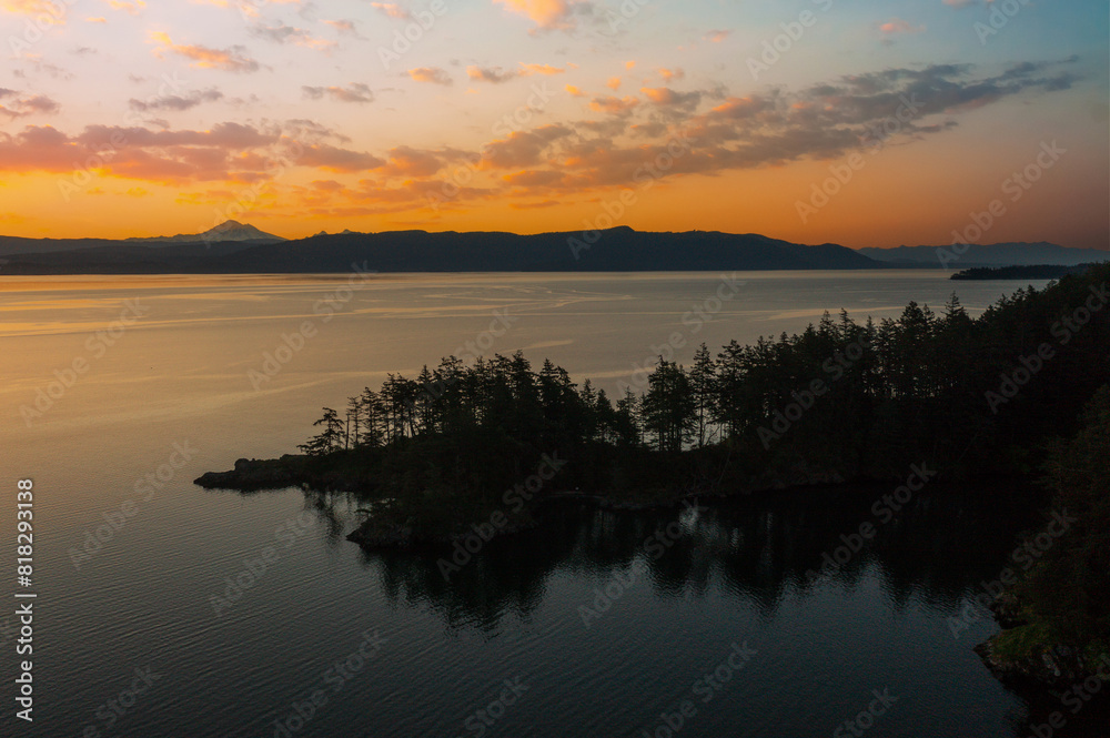 Fototapeta premium Abner Point on Lummi Island with Mt. Baker in the background. Seen from the Aiston Preserve with Smugglers Cove in the foreground and Bellingham Bay and the city of Bellingham in the distance.
