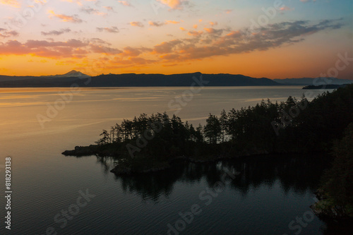 Abner Point on Lummi Island with Mt. Baker in the background. Seen from the Aiston Preserve with Smugglers Cove in the foreground and Bellingham Bay and the city of Bellingham in the distance.