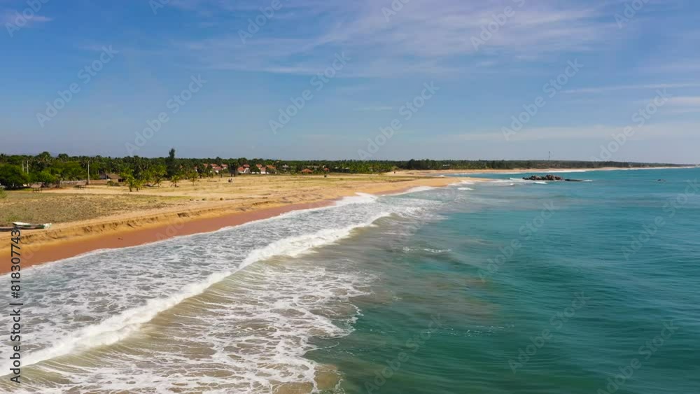 A tropical beach with palm trees and a blue ocean. Whiskey point, Sri Lanka. A tropical beach with palm trees and a blue ocean. Whiskey point, Sri Lanka.