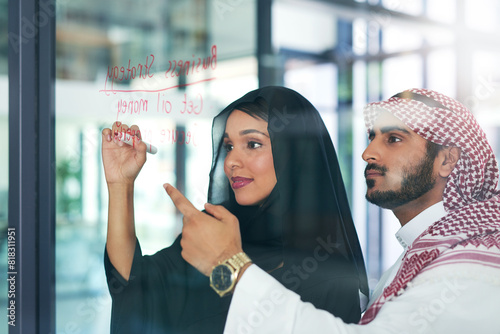 Arab, business and people writing on glass, strategy and meeting for our vision or oil company financial plan. Muslim employee, development and collaboration, innovation and brainstorming in Dubai photo