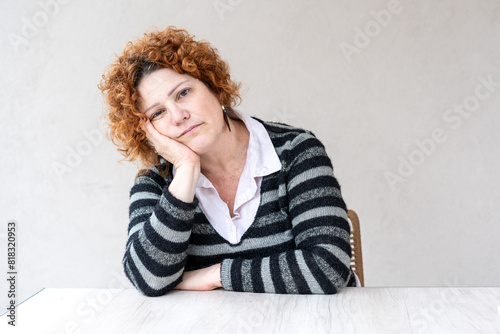 Portrait of a mid-adult redhead woman looking at the camera