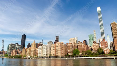 New York city skyline time lapse - midtown Manhattan and upper east side hyper lapse. Waterfront cityscape of urban metropolis downtown with tall buildings in the United States of America.