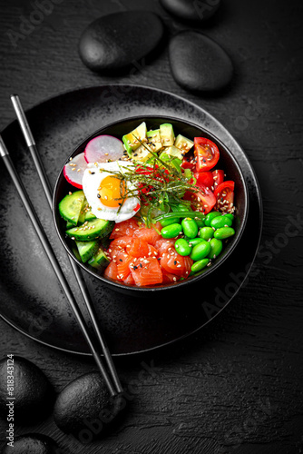 Salmon Poke bowl composition on black background. The Art of Japanese Cuisine. Food photography for menu and sushi bar decoration