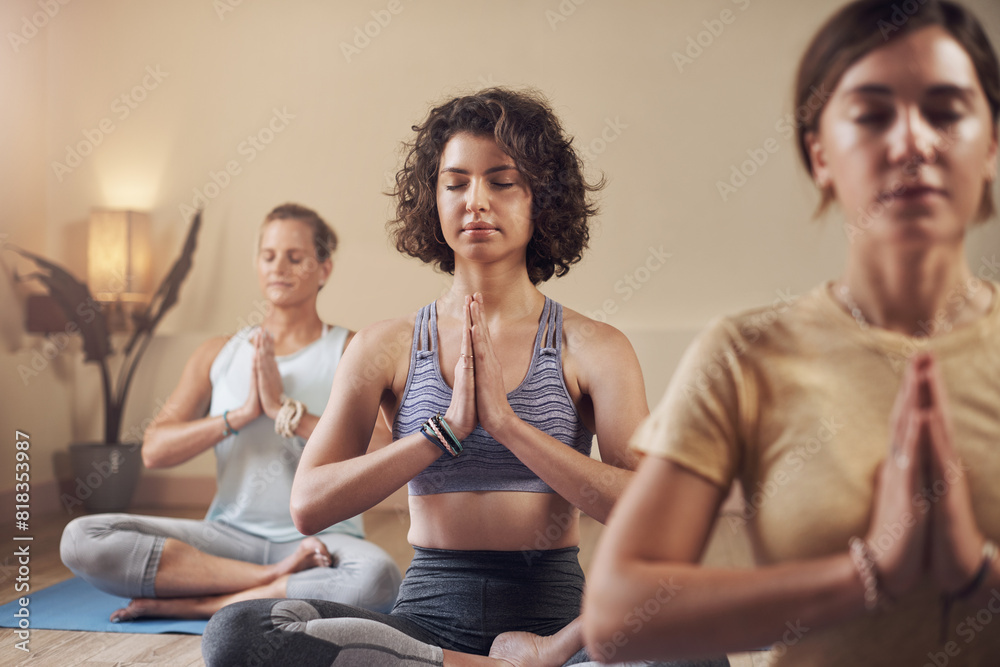 Meditation, yoga group and women in gym for peace, mindfulness and spiritual wellness with chakra balance. Pilates girls, health class and lotus pose for zen soul and prayer hands for healing aura