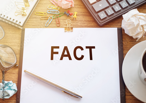 A piece of paper with the word Fact written on it