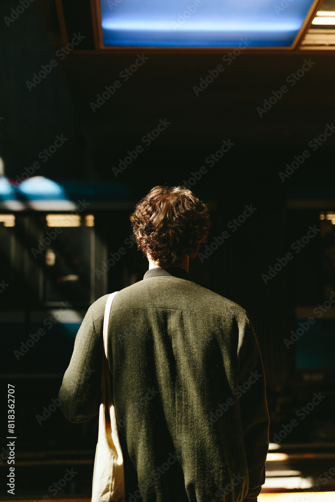 Man in shadow with brightly lit background in urban setting Man in shadow with brightly lit background in urban setting