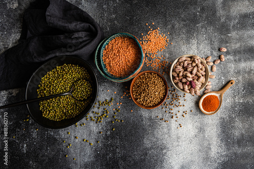 Assorted raw beans and legumes on textured surface photo