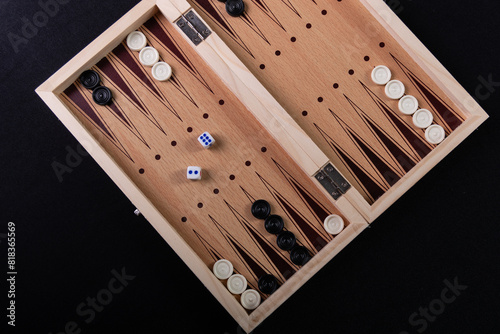 Board to play backgammon with pieces and dice. Board game, pastime, fun.