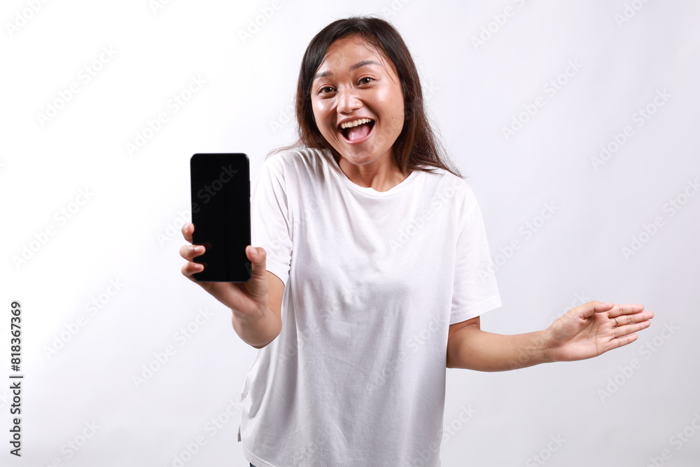 Portrait of young happy woman, looking pleased and surprised while showing blank phone screen. Isolated on white Portrait of young happy woman, looking pleased and surprised while showing blank phone screen. Isolated on white