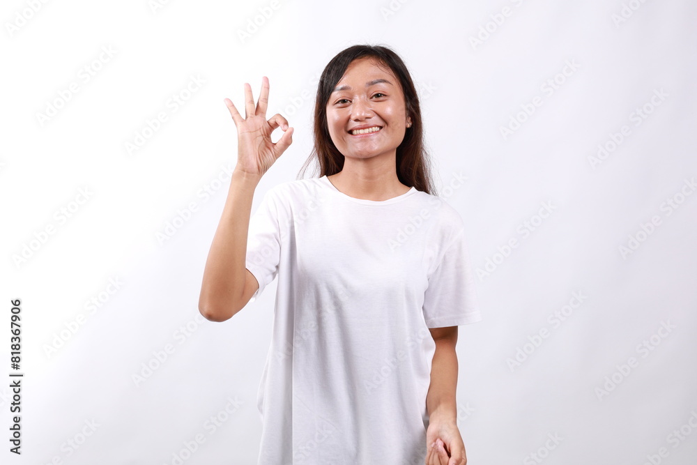 Smiling asian woman showing okay, Very good with satisfied face expression, praise and compliment great job, pleased by smth, standing over white background Smiling asian woman showing okay, Very good with satisfied face expression, praise and compliment great job, pleased by smth, standing over white background