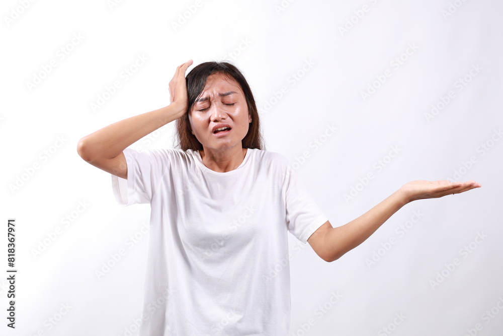 Stressed young attractive asian woman showing confused gesture while holding her head with unhappy emotion, standing over white background Stressed young attractive asian woman showing confused gesture while holding her head with unhappy emotion, standing over white background