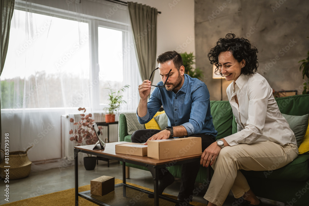 Mature caucasian woman and adult man check packets on clipboard Mature caucasian woman and adult man check packets on clipboard