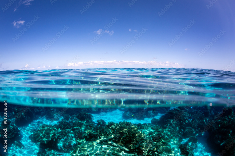 Above below view of a tropical reef lagoon under blue sky