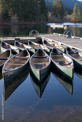 Canoes are reflected in the lake water during the summer on Alta Lake in Whistler BC photo
