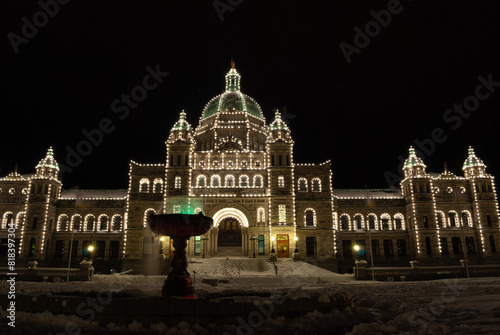 The legislature of British Columbia on a snowy night in winter lit up by Christmas lights in Victoria BC