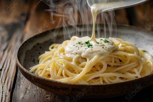 A bowl of pasta with a white sauce poured over it photo